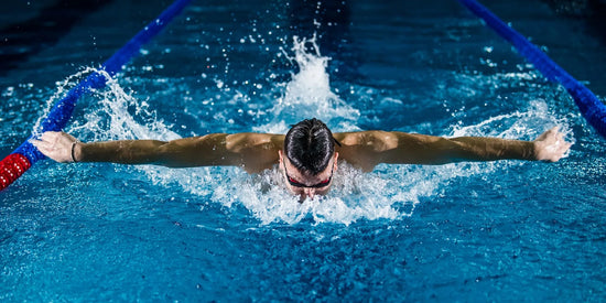 Athlete applying kinesiology tape for shoulder support before training