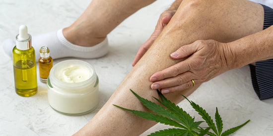 A person applying topical CBD cream to their knee for joint pain.